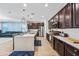 Spacious kitchen with stainless appliances, central island with bar seating, and rich wood cabinets at 20251 W Hadley St, Buckeye, AZ 85326