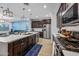 Modern kitchen boasts stainless appliances, a large island with bar seating, and stylish pendant lighting at 20251 W Hadley St, Buckeye, AZ 85326