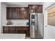 Open kitchen design with stainless steel refrigerator, abundant cabinetry, and a convenient water dispenser at 20251 W Hadley St, Buckeye, AZ 85326