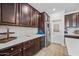 Kitchen features white countertops, stainless steel fridge, and warm wood cabinets at 20251 W Hadley St, Buckeye, AZ 85326