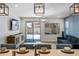 Bright living room with stylish decor, modern lighting, and sliding doors to the patio at 20251 W Hadley St, Buckeye, AZ 85326
