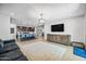 Bright open-concept living space with modern décor, open to the kitchen and dining area at 20251 W Hadley St, Buckeye, AZ 85326