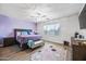 Cozy main bedroom featuring a neutral color scheme, fan, and a large window at 20251 W Hadley St, Buckeye, AZ 85326