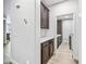 Mud room features dark wood cabinets with white counter, offering convenience and extra storage at 20251 W Hadley St, Buckeye, AZ 85326