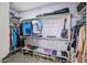 Spacious walk-in closet features custom shelving for clothes, shoes, and accessories with a stylish gray wood-look floor at 20251 W Hadley St, Buckeye, AZ 85326