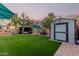 Backyard showcases artificial grass, a gazebo, shed, and decorative lighting for outdoor enjoyment at 2038 N Los Alamos St, Mesa, AZ 85213