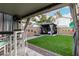 Tranquil backyard with artificial turf, gazebo lounge area, and decorative wall accents at 2038 N Los Alamos St, Mesa, AZ 85213