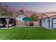 Spacious backyard with artificial grass, a shed, a gazebo, and string lights for ambiance at 2038 N Los Alamos St, Mesa, AZ 85213
