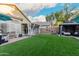 Expansive backyard features artificial turf, a gazebo, and a covered patio, creating an inviting outdoor space at 2038 N Los Alamos St, Mesa, AZ 85213