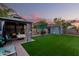 Lush backyard features a gazebo, a shed, manicured lawn, and a cozy seating area at 2038 N Los Alamos St, Mesa, AZ 85213