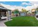 Charming backyard offers a well-maintained lawn, storage shed, and shaded seating with gazebo at 2038 N Los Alamos St, Mesa, AZ 85213