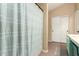 Bathroom with bathtub/shower combo featuring blue and white striped shower curtain and tiled floors at 2038 N Los Alamos St, Mesa, AZ 85213