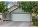 Home featuring a spacious garage, desert landscaping, and neutral color scheme at 2038 N Los Alamos St, Mesa, AZ 85213
