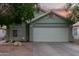 Charming single-story home with a two-car garage, xeriscape landscaping, and warm exterior lights at 2038 N Los Alamos St, Mesa, AZ 85213
