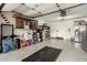 Spacious garage featuring storage cabinets, refrigerator, and lots of open space at 2038 N Los Alamos St, Mesa, AZ 85213