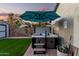 Backyard hot tub area featuring an umbrella and steps for easy access to the soothing water at 2038 N Los Alamos St, Mesa, AZ 85213