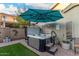 Backyard hot tub and seating area shaded by a stylish market umbrella at 2038 N Los Alamos St, Mesa, AZ 85213