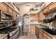 Practical kitchen layout with stainless steel appliances, wooden cabinets, and neutral countertops at 2038 N Los Alamos St, Mesa, AZ 85213