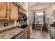 Practical kitchen area featuring stainless steel appliances, wooden cabinetry, and tiled flooring at 2038 N Los Alamos St, Mesa, AZ 85213