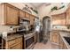 Functional kitchen featuring stainless steel appliances and wooden cabinetry at 2038 N Los Alamos St, Mesa, AZ 85213