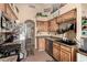 Well-lit kitchen featuring stainless steel appliances, wood cabinets, and tiled floors at 2038 N Los Alamos St, Mesa, AZ 85213