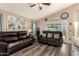 Spacious living room with vaulted ceilings, wood-look floors, and comfortable leather sofas at 2038 N Los Alamos St, Mesa, AZ 85213