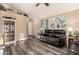 Cozy living room showcasing wood-look floors, a leather sofa, and a decorative art piece at 2038 N Los Alamos St, Mesa, AZ 85213