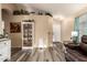 Open living space with wood floors, decorative shelving, and a bright entryway at 2038 N Los Alamos St, Mesa, AZ 85213