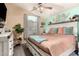 Comfortable main bedroom features a ceiling fan, an upholstered headboard, and soft carpet at 2038 N Los Alamos St, Mesa, AZ 85213