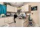 Bright office space with built-in cabinets, desk space, and overhead lighting at 2038 N Los Alamos St, Mesa, AZ 85213