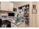 Office space featuring a desk with built-in storage and ample shelving at 2038 N Los Alamos St, Mesa, AZ 85213