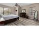 Cozy bedroom features natural light, a ceiling fan, wood-look floors, and neutral décor at 20660 N 40Th St # 1118, Phoenix, AZ 85050