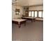 Community billiards room with two pool tables, overhead lighting and seating area at 20660 N 40Th St # 1118, Phoenix, AZ 85050