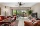 Spacious living room with light wood floors, a fan, and sliding glass doors to the backyard at 20660 N 40Th St # 1118, Phoenix, AZ 85050