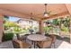 Covered outdoor dining area features ceiling fans, stone table, and chairs, perfect for entertaining near the pool at 20660 N 40Th St # 1118, Phoenix, AZ 85050