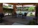 Covered patio seating near pool features ceiling fans, large table and chairs; an ideal space for outdoor entertaining at 20660 N 40Th St # 1118, Phoenix, AZ 85050