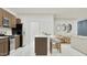 Modern kitchen with stainless steel appliances, a center island with seating, and an open layout connecting to the dining area at 20888 S 231St Way, Queen Creek, AZ 85142