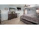 Bright main bedroom with soft blue walls, large bed, and TV at 2116 S Shelby --, Mesa, AZ 85209