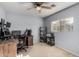 Bedroom features a ceiling fan, a built-in desk with black rolling chair and a window at 2116 S Shelby --, Mesa, AZ 85209