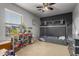 Bedroom featuring a dollhouse, bed, carpet, ceiling fan, and dark accent wall at 2116 S Shelby --, Mesa, AZ 85209