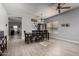 Bright dining area featuring a ceiling fan, modern light fixture, and dark wood dining set at 2116 S Shelby --, Mesa, AZ 85209