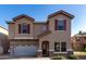 Inviting two-story home featuring a well-manicured front yard, a red tile roof, and a two-car garage at 2116 S Shelby --, Mesa, AZ 85209