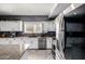 Updated kitchen with white cabinets, granite countertops, and stainless steel appliances at 2116 S Shelby --, Mesa, AZ 85209