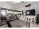 Open-concept living area features a large sectional, kitchen access, and mounted TV at 2116 S Shelby --, Mesa, AZ 85209