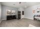 Cozy living area with wood-look floors, bright natural light, and access to the home's exterior at 2116 S Shelby --, Mesa, AZ 85209