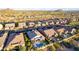 Aerial view of a community with backyard pools, desert landscaping, and mountain views at 2166 N Steele --, Mesa, AZ 85207