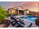Beautiful backyard pool area featuring lounge chairs, lush landscaping, and outdoor living space at 2166 N Steele --, Mesa, AZ 85207