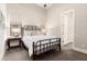 Bright bedroom featuring a metal bed frame, neutral walls, and an ensuite door at 2166 N Steele --, Mesa, AZ 85207