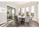 Bright dining room with a round table, stylish chairs, and access to outdoor patio at 2166 N Steele --, Mesa, AZ 85207