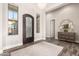 Elegant entryway featuring a decorative front door, wood floors, and stylish furnishings at 2166 N Steele --, Mesa, AZ 85207